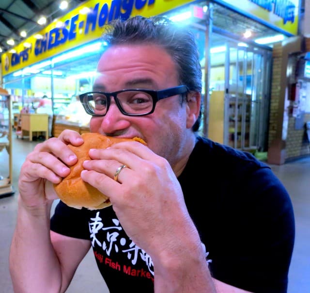 Biting into a Peameal Bacon Sandwich in Toronto Canada