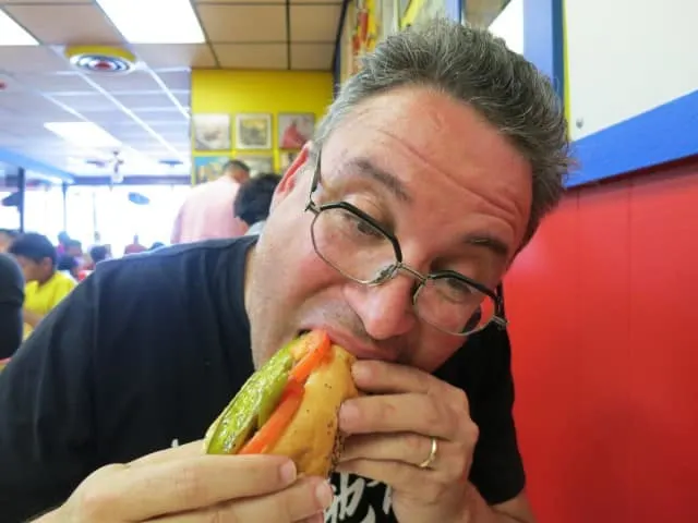 Daryl Bites into a Chi Dog at Hot Doug's in Chicago