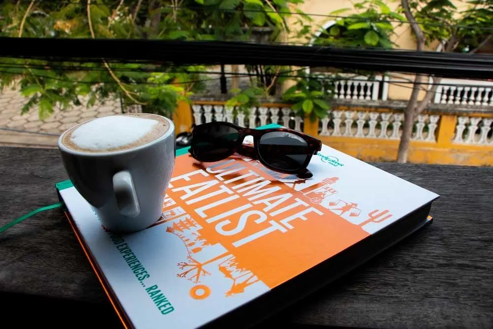 Lonely Planet Ultimate Eatlist with Coffee and Sunglasses