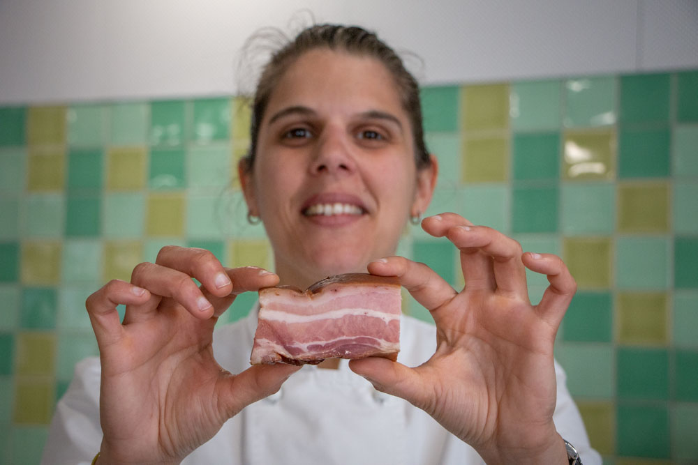Ana Vicoso Holds Bacon at Lisbon Cooking Academy