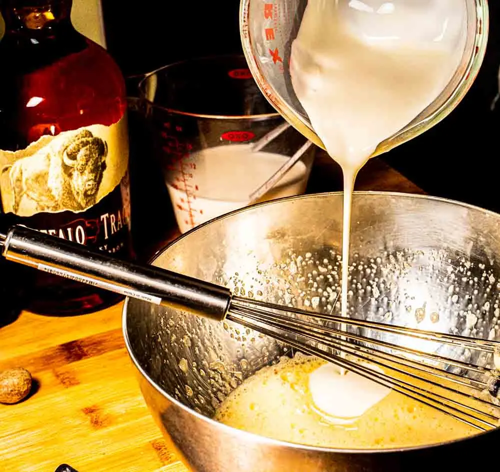 Pouring Cream into Bourbon Eggnog