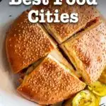 Pinterest image: image of a Muffaletta with caption reading "America's Best Food Cities"