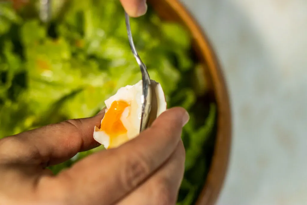 Adding Coddled Egg to Caesar Salad