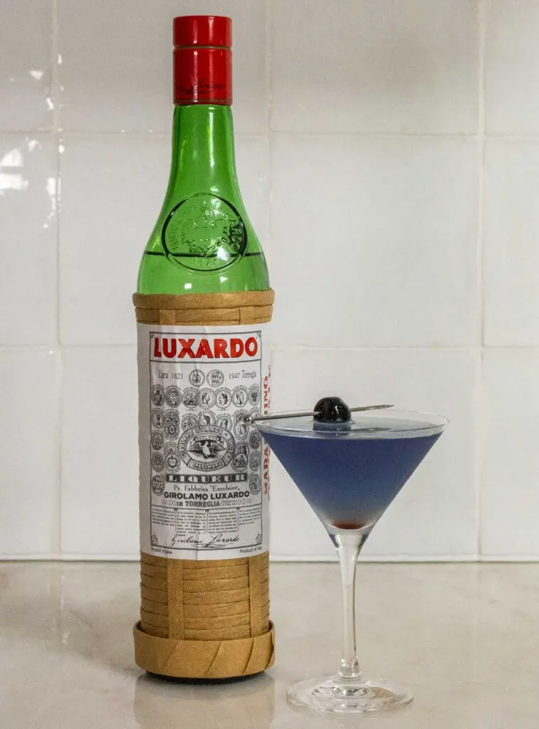 Aviation Cocktail Next to Luxardo Maraschino Liqueur