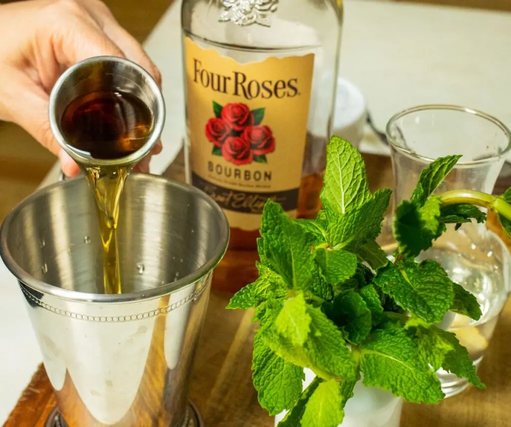 Pouring Bourbon into Mint Julep