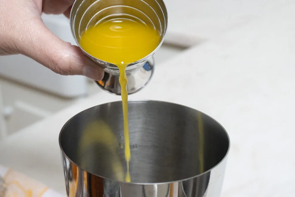 Pouring Orange Juice into Shaker