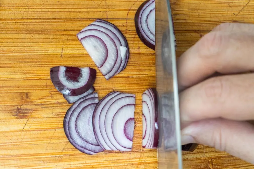 Slicing Red Onion on Wood Cutting Board