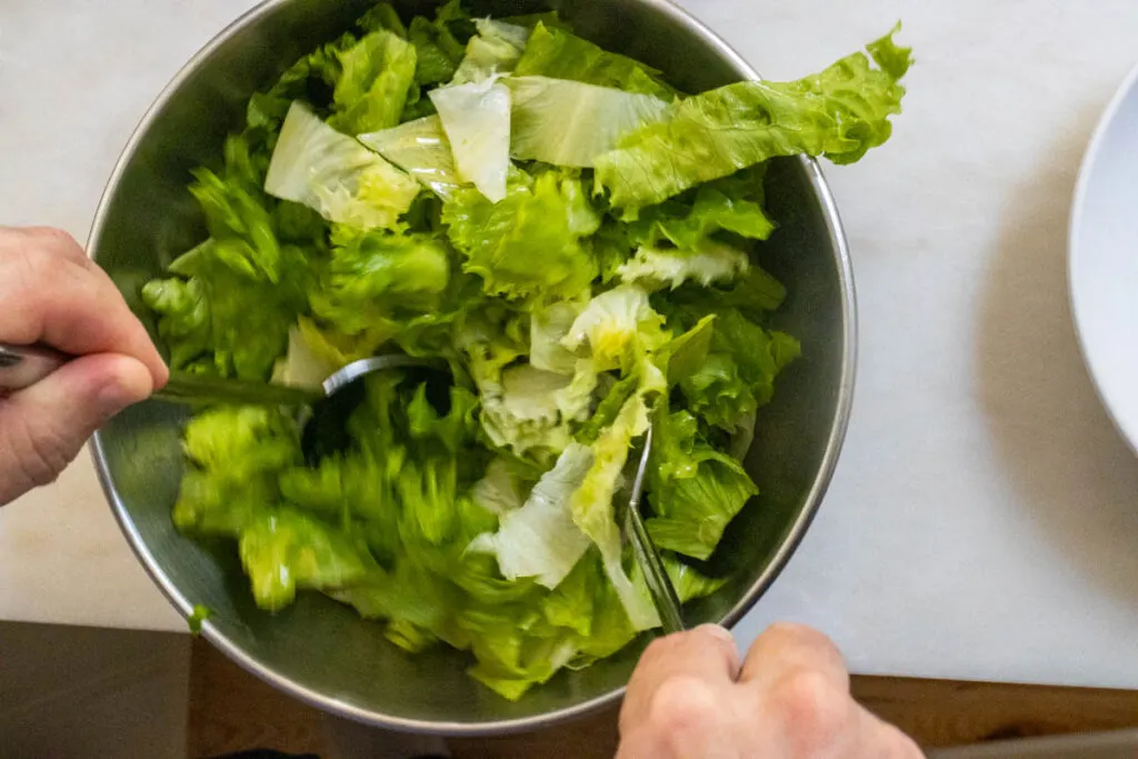 Tossing romaine with Salad Dressing