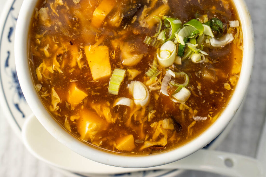 Closeup of Hot and Sour Soup with Spoon