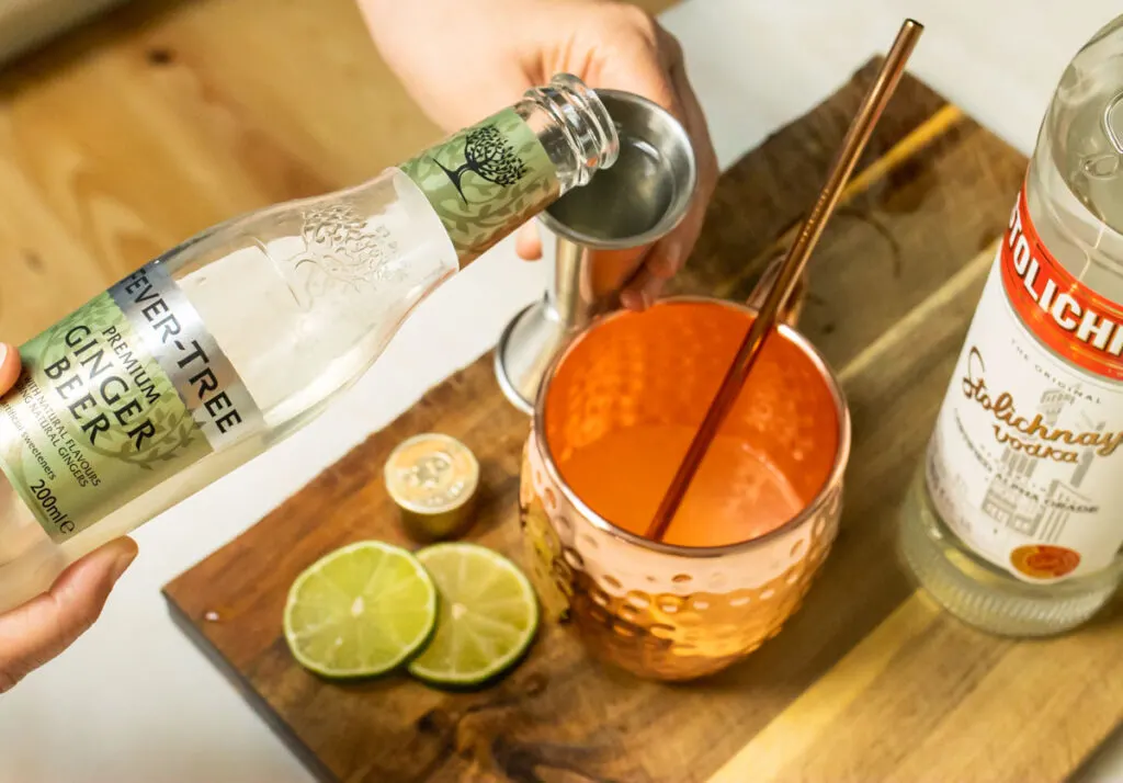 Pouring Ginger Beer into Moscow Mule
