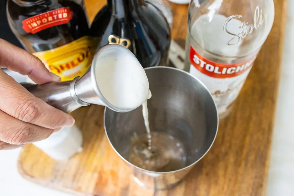 Pouring Cream into Mudslide Cocktail