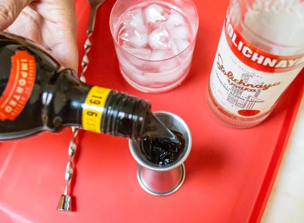 Pouring Kahlua for Black Russian Cocktail
