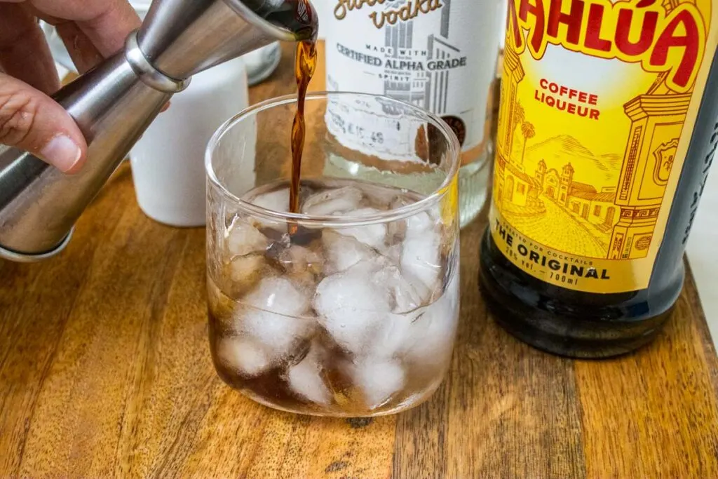 Pouring Kahlua in a Rocks Glass w Ice