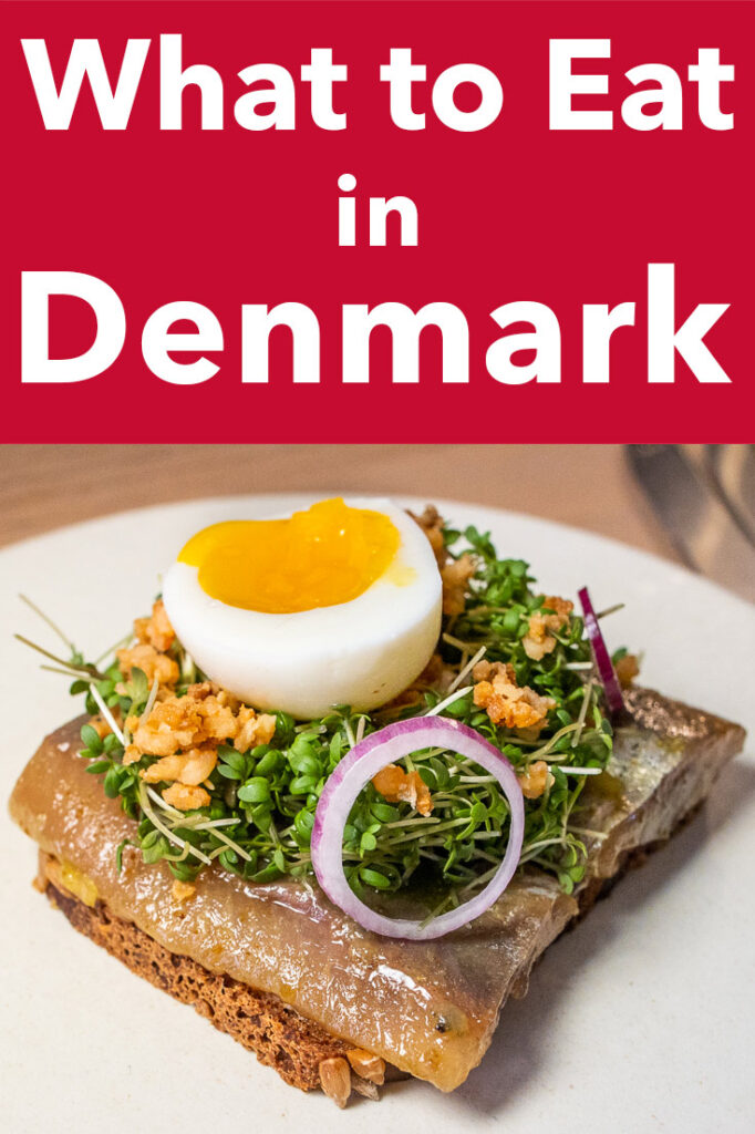 Pinterest image: Herring Smorrebrod with caption reading "What to Eat in Denmark"