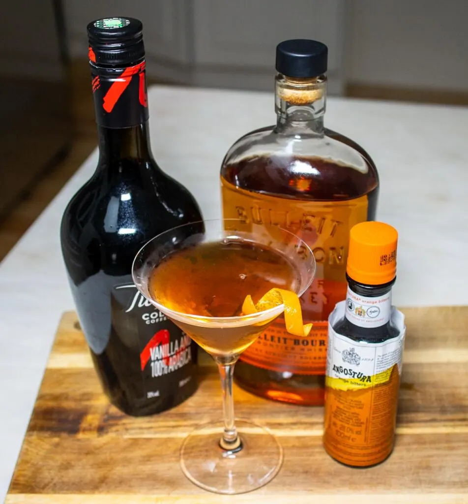 Crafted Revolver Cocktail with Liquor Bottles