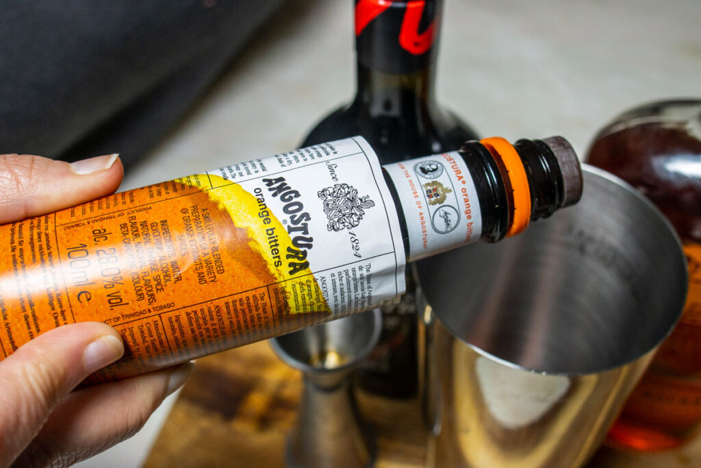 Dashing Orange Bitters into Revolver Cocktail Recipe