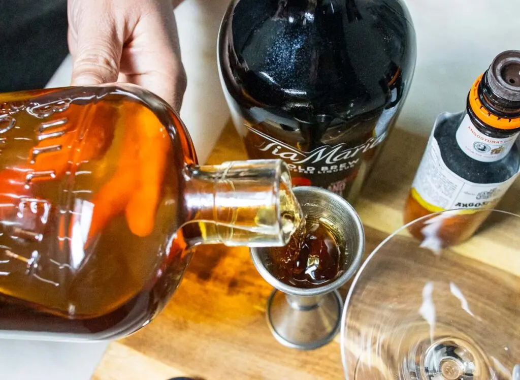 Measuring Bourbon for Revolver Cocktail Recipe