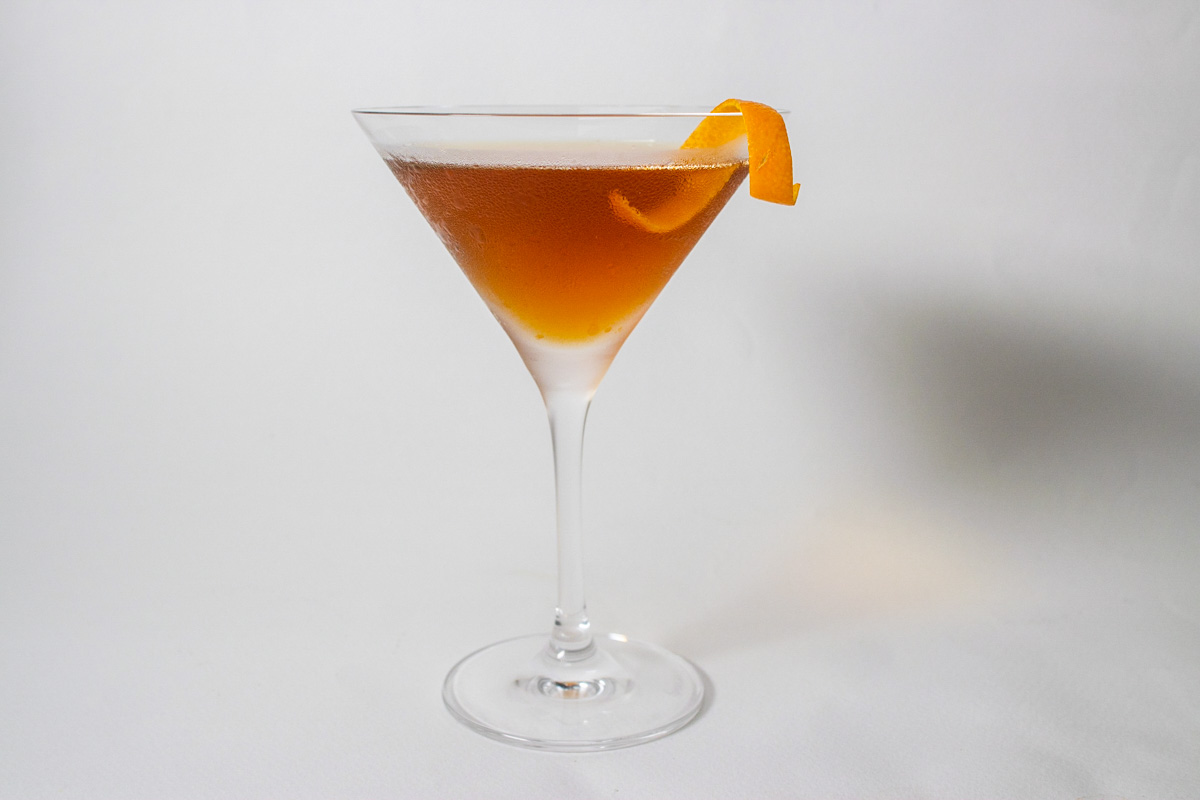 Revolver Cocktail with Orange Twist and White Background