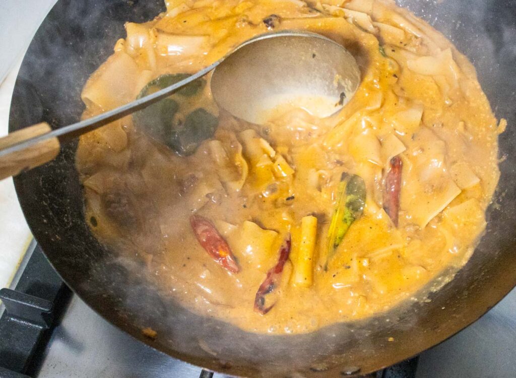 Stirring and Cooking Thai Panang Curry in Wok