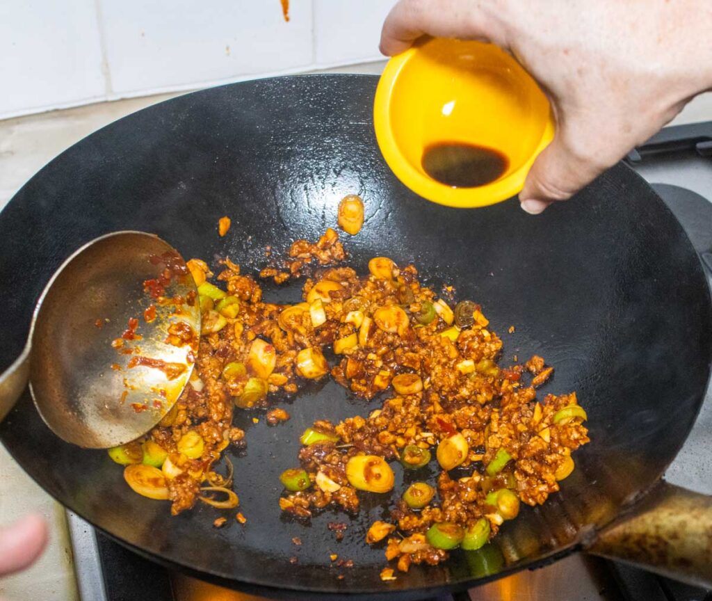 Adding Soy Sauce to a Wok