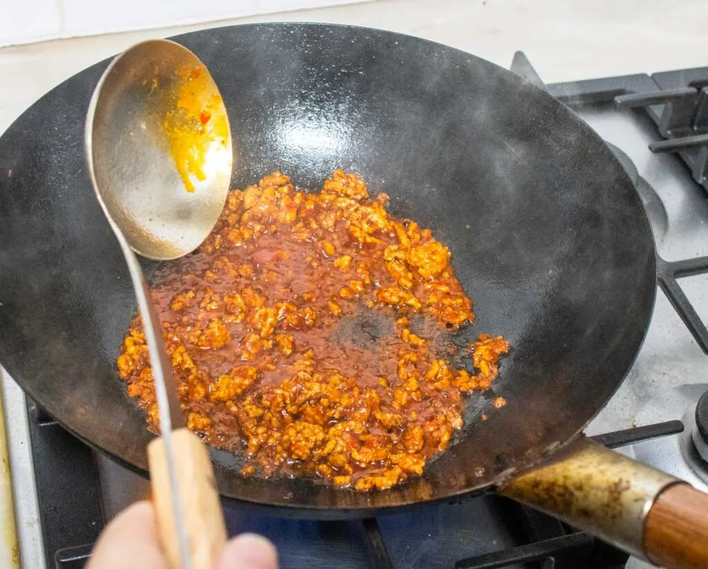 Chili Bean Paste mixed with Ground Pork in a wok