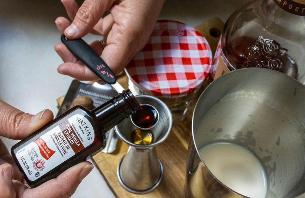 Measuring Vanilla Extract for Bourbon Milk Punch Recipe