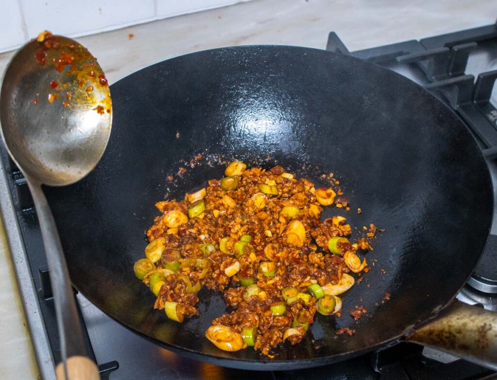 Mirepoix in a wok mixed with ground pork