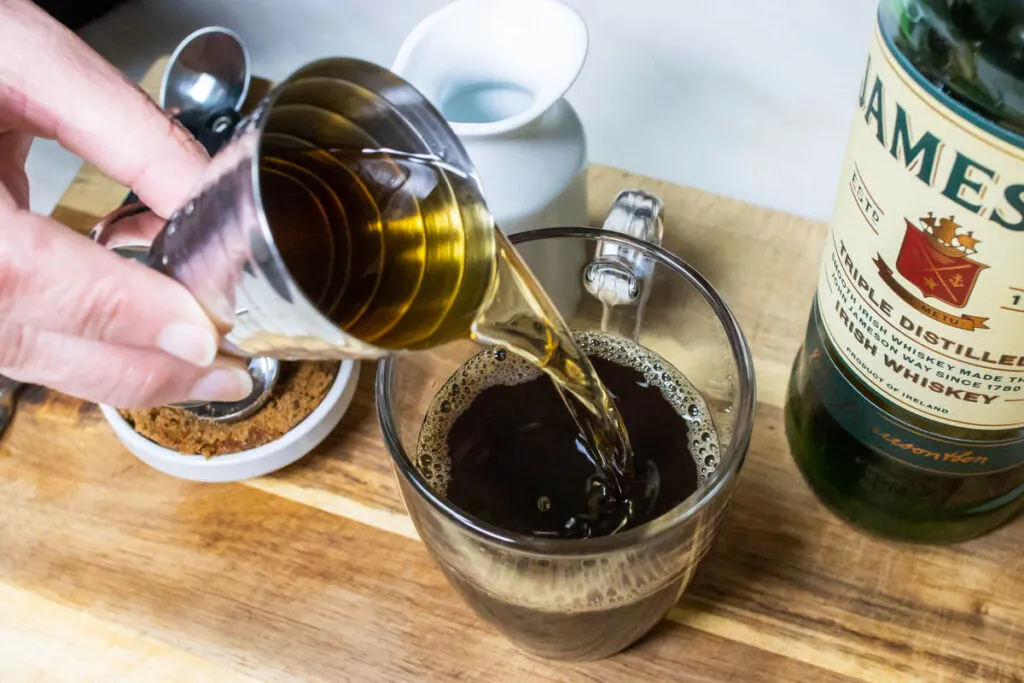 Pouring Irish Whiskey for Irish Coffee Recipe