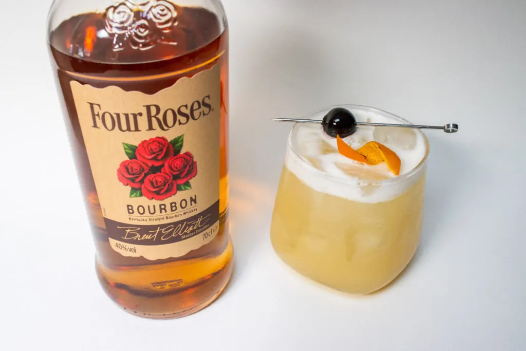 Whiskey Sour Next to Four Roses Bourbon Bottle
