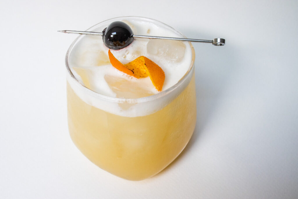 Whiskey Sour with Cherry and Orange Twist