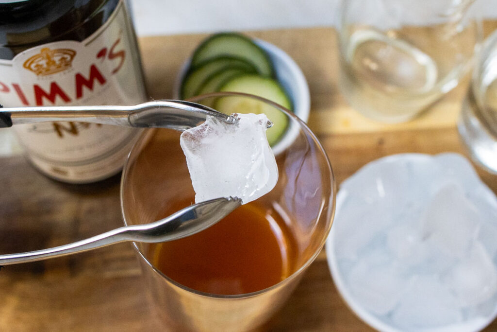 Adding Ice to Pimms Cup Cocktail
