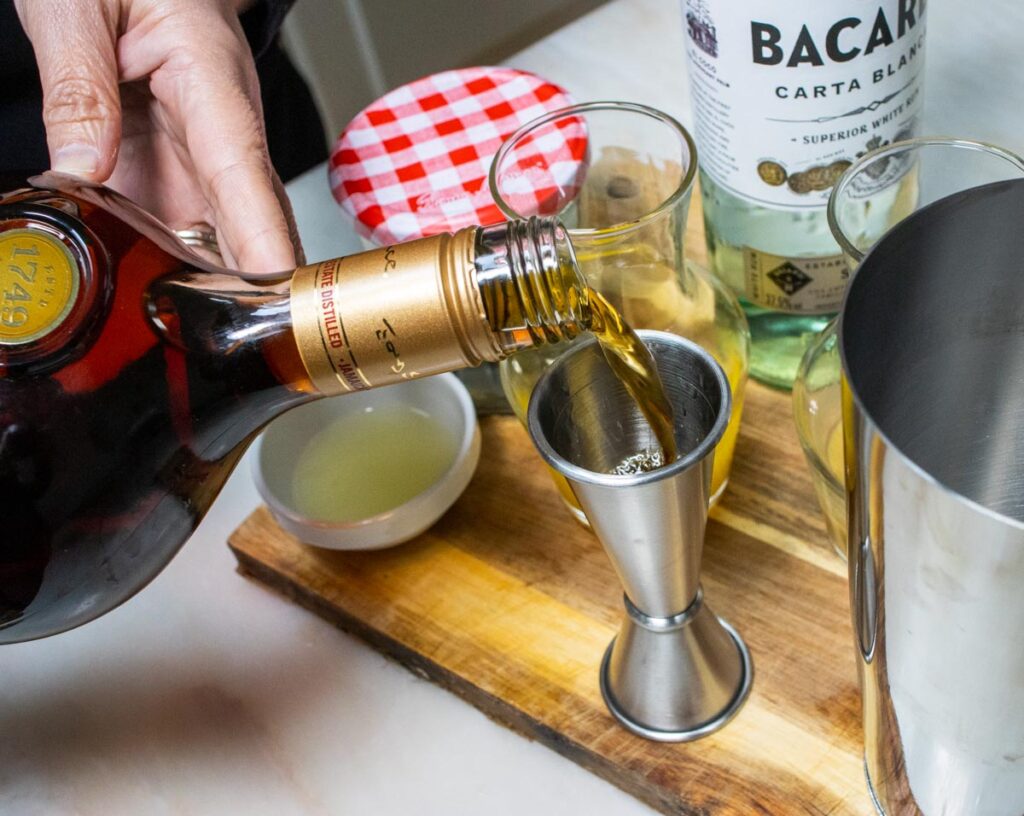 Measuring Dark Rum for Hurricane Cocktail Recipe