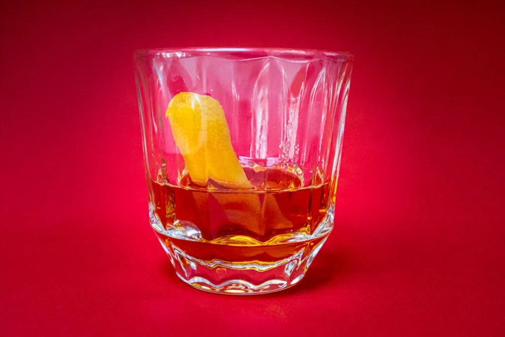 Sazerac Cocktail with Red Background