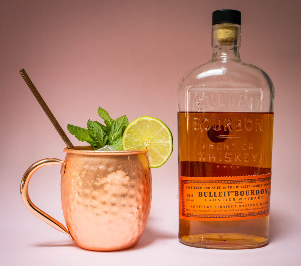 Kentucky Mule and Bourbon Bottle with Pink Background