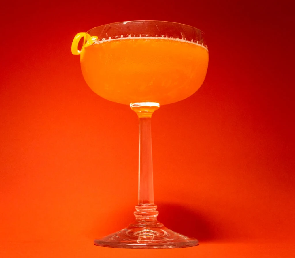 Paper Plane Cocktail with Red Background from Below