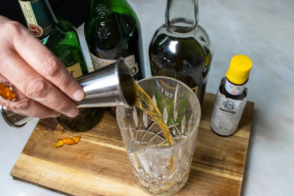 Pouring Irish Whiskey to craft a Tipperary Cocktail