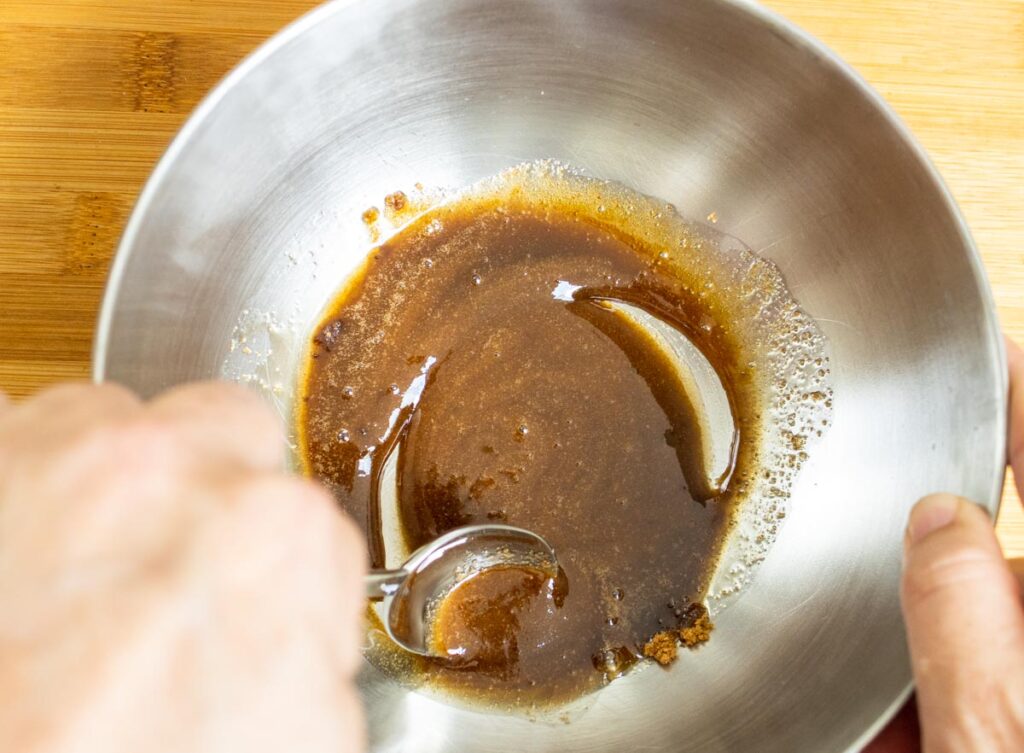 Mixing brown sugar with maple syrup and salt