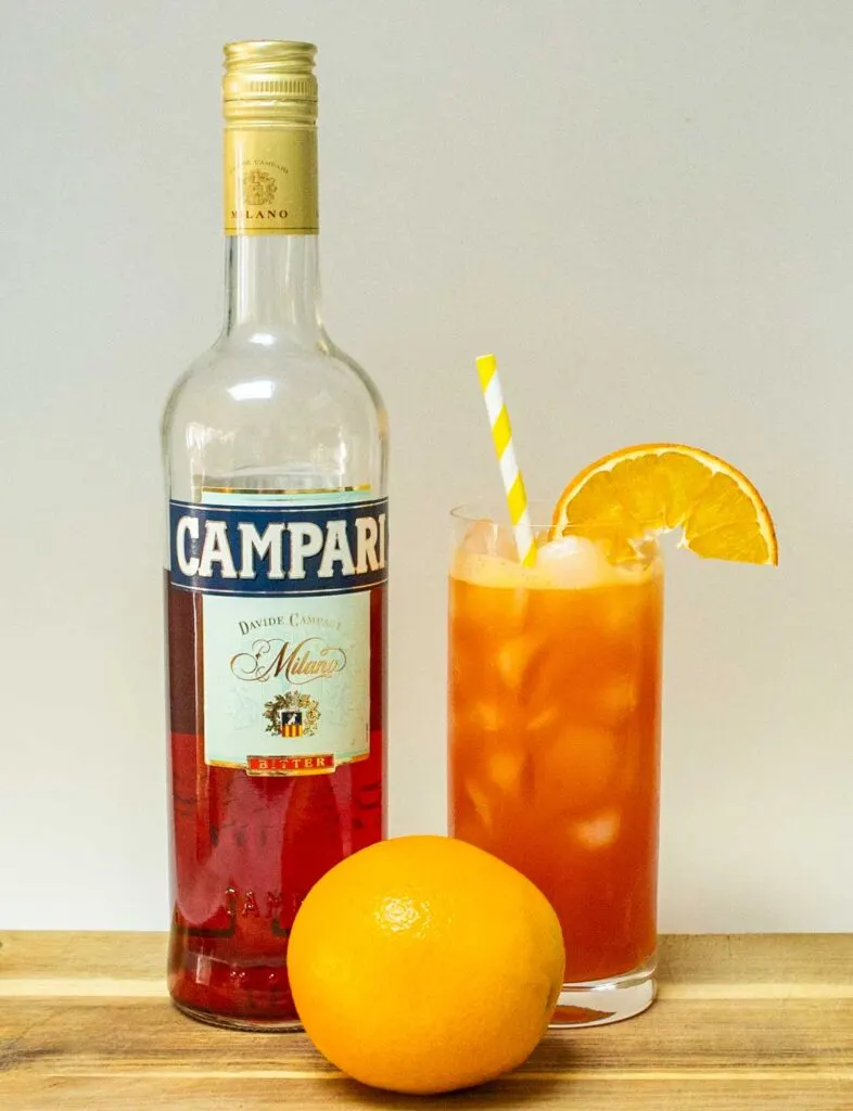 Garibaldi Cocktail with Campari Bottle and White Background