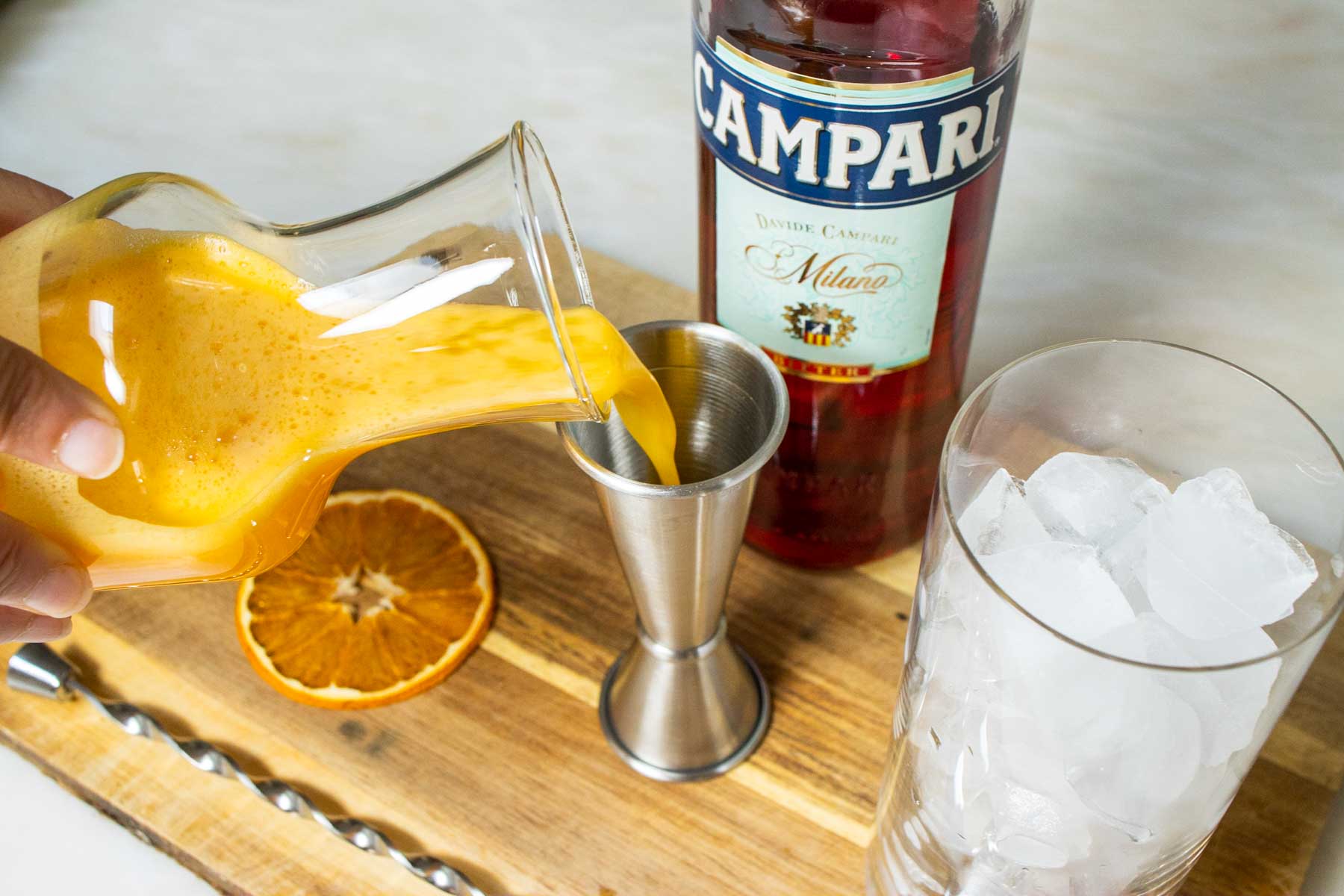 Measuring Orange Juice for a Garibaldi Cocktail