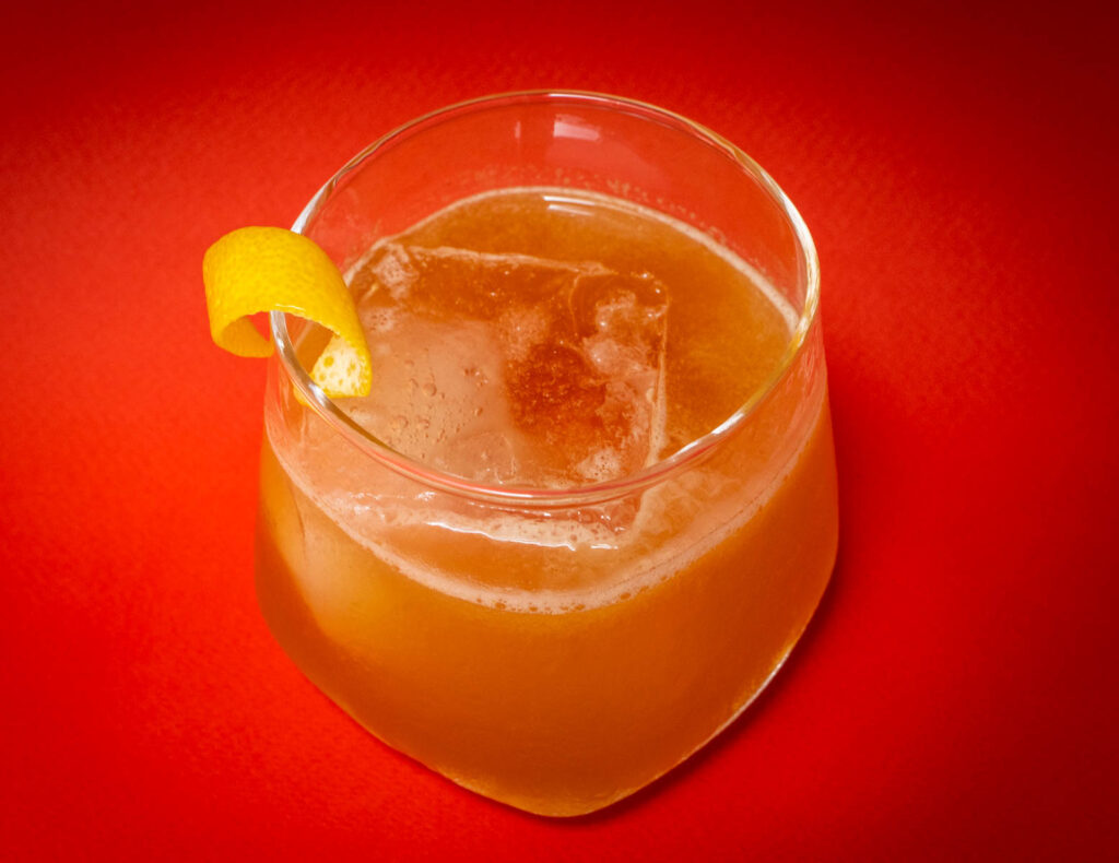 Gold Rush Cocktail from Above with Red Background