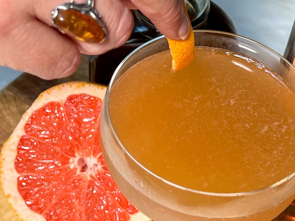 Expressing Grapefruit Peel on Brown Derby Cocktail