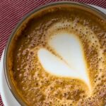 Pinterest image: photo of coffee with heart art with caption reading "The Best Cafes Graz"