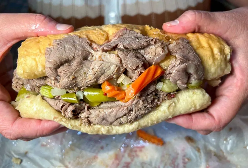 Italian Beef Sandwich in Hands at Portillos in Chicago