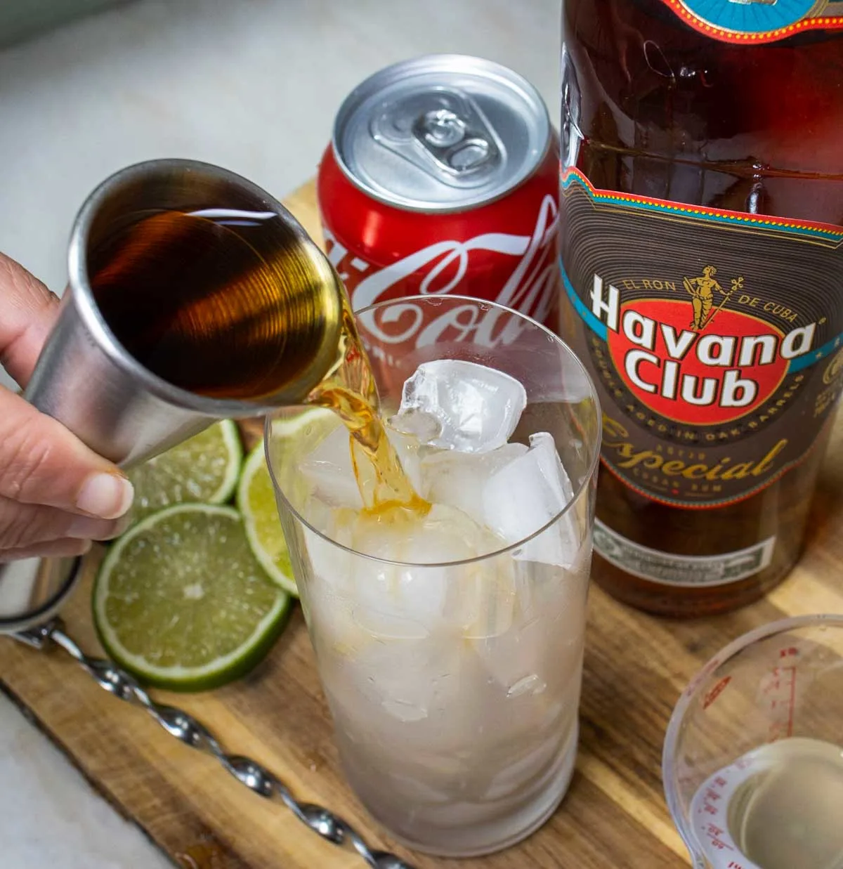 Pouring Rum into Cuba Libre Cocktail
