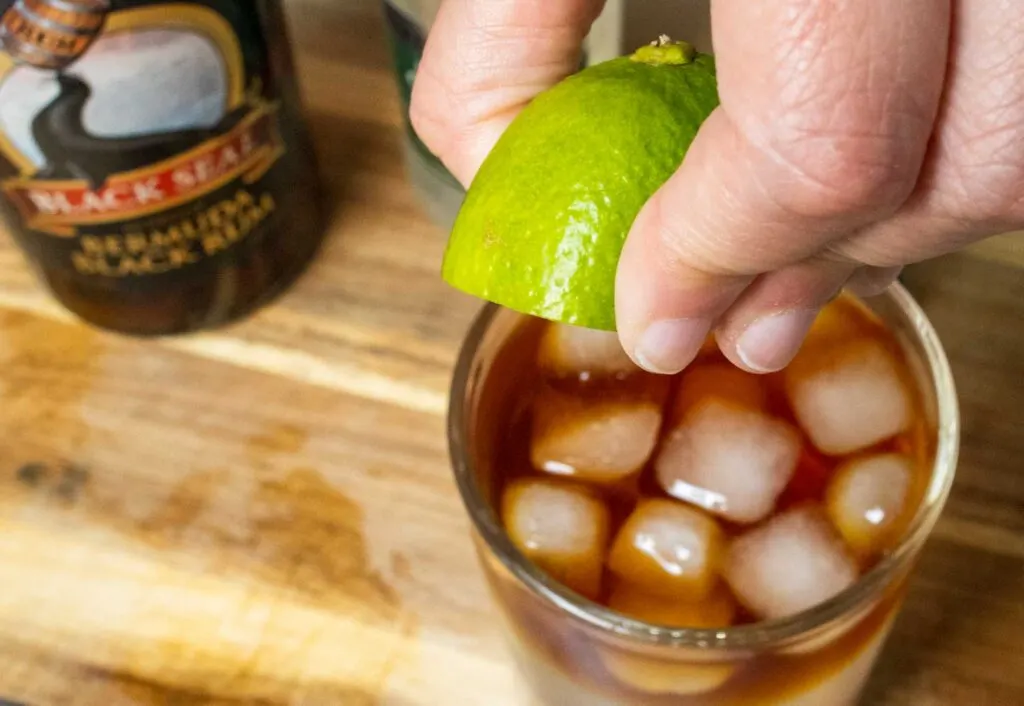 Squeezing Lime Juice into a Dark and Stormy Cocktail