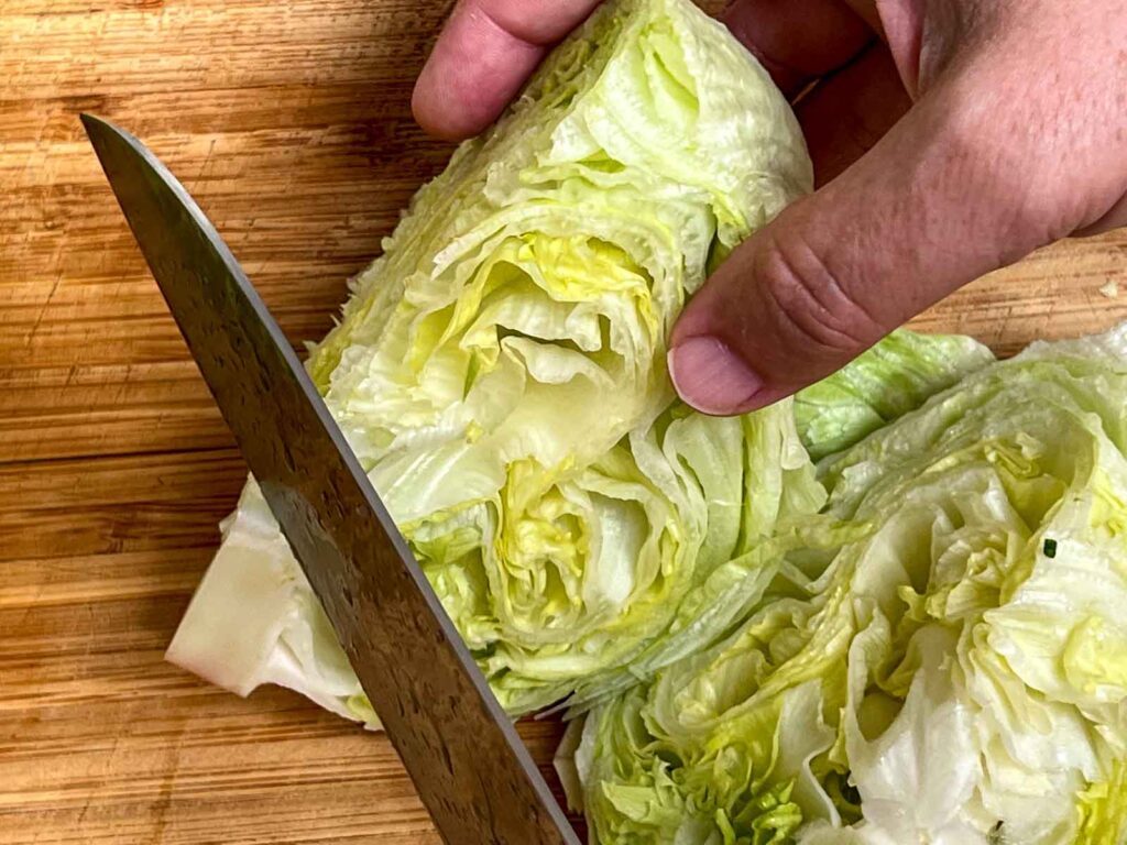 Chopping the root off Iceberg lettuce for wedge salad