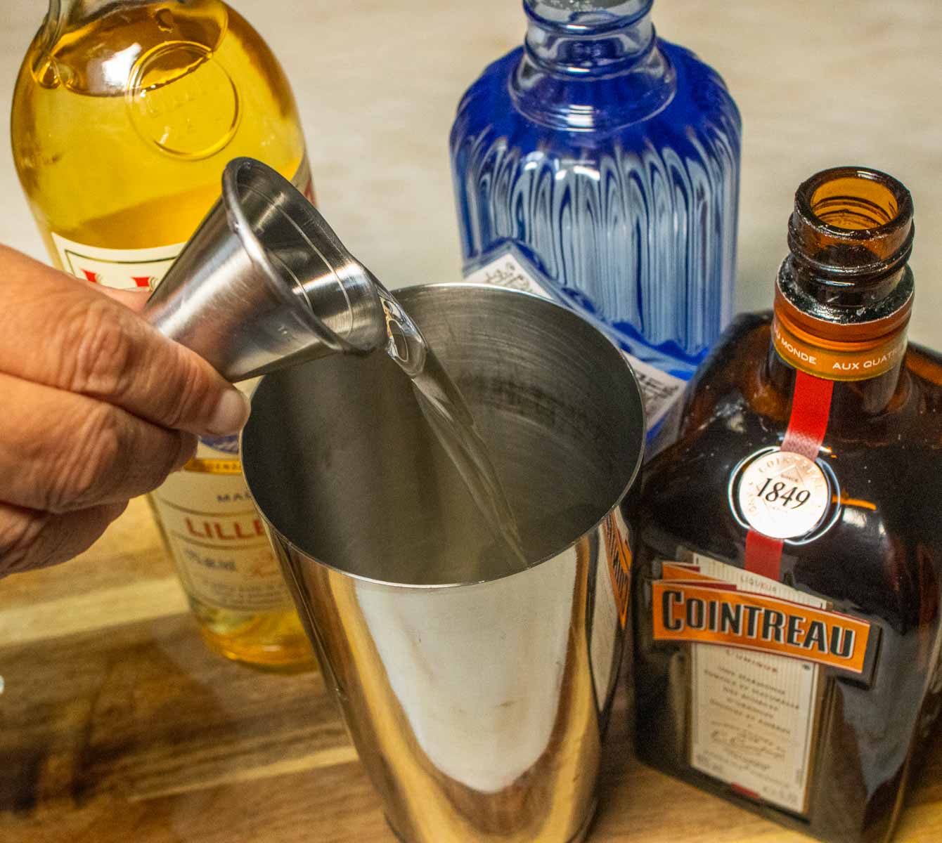 Pouring Lillet Blanc into Corpse Reviver No. 2 Cocktail