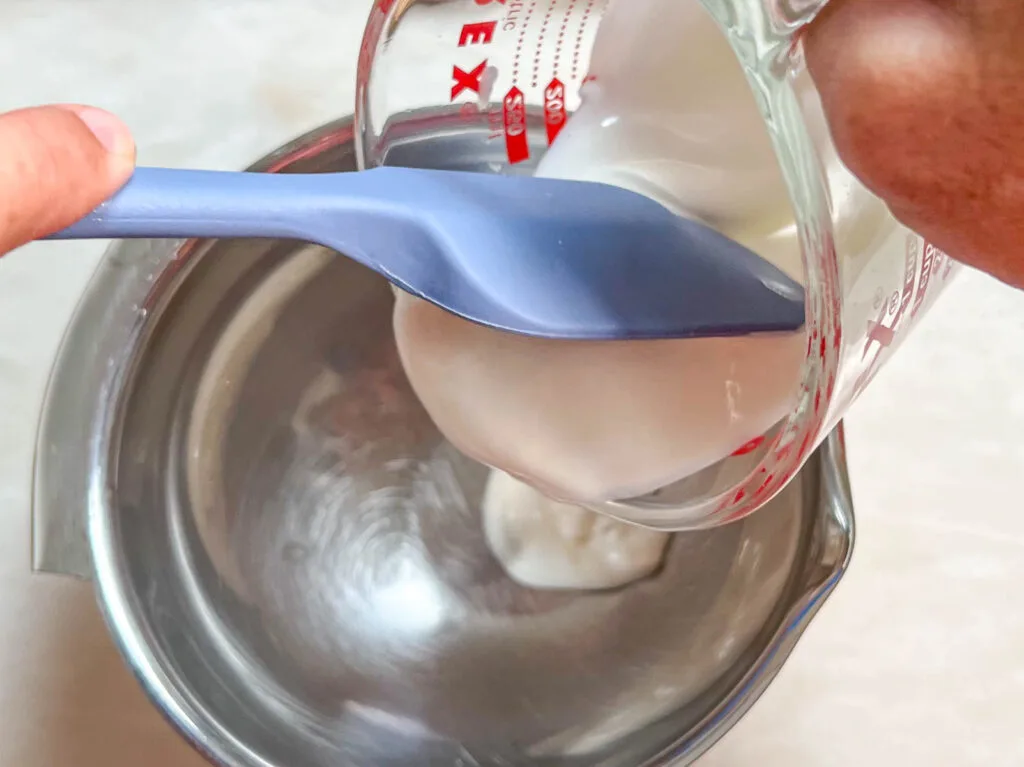 Pouring Yogurt into a mixing bowl