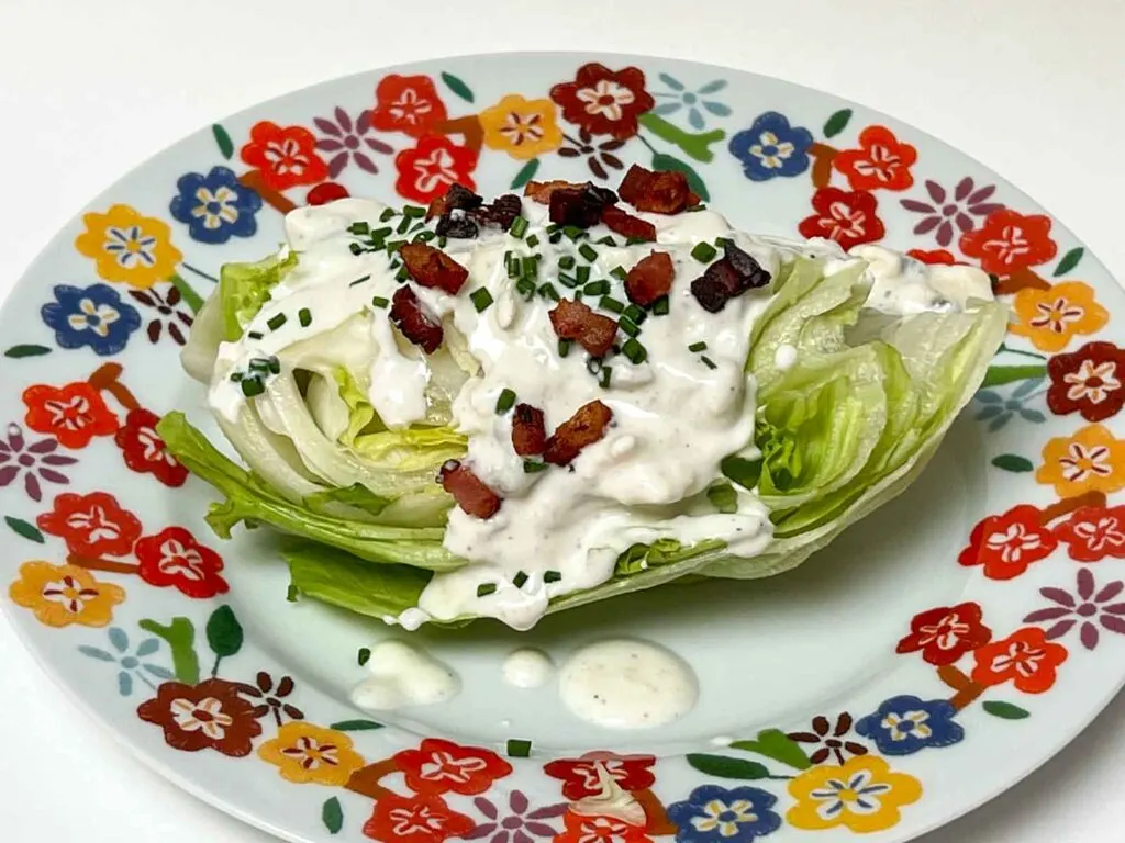Wedge salad on a flower rimmed plate