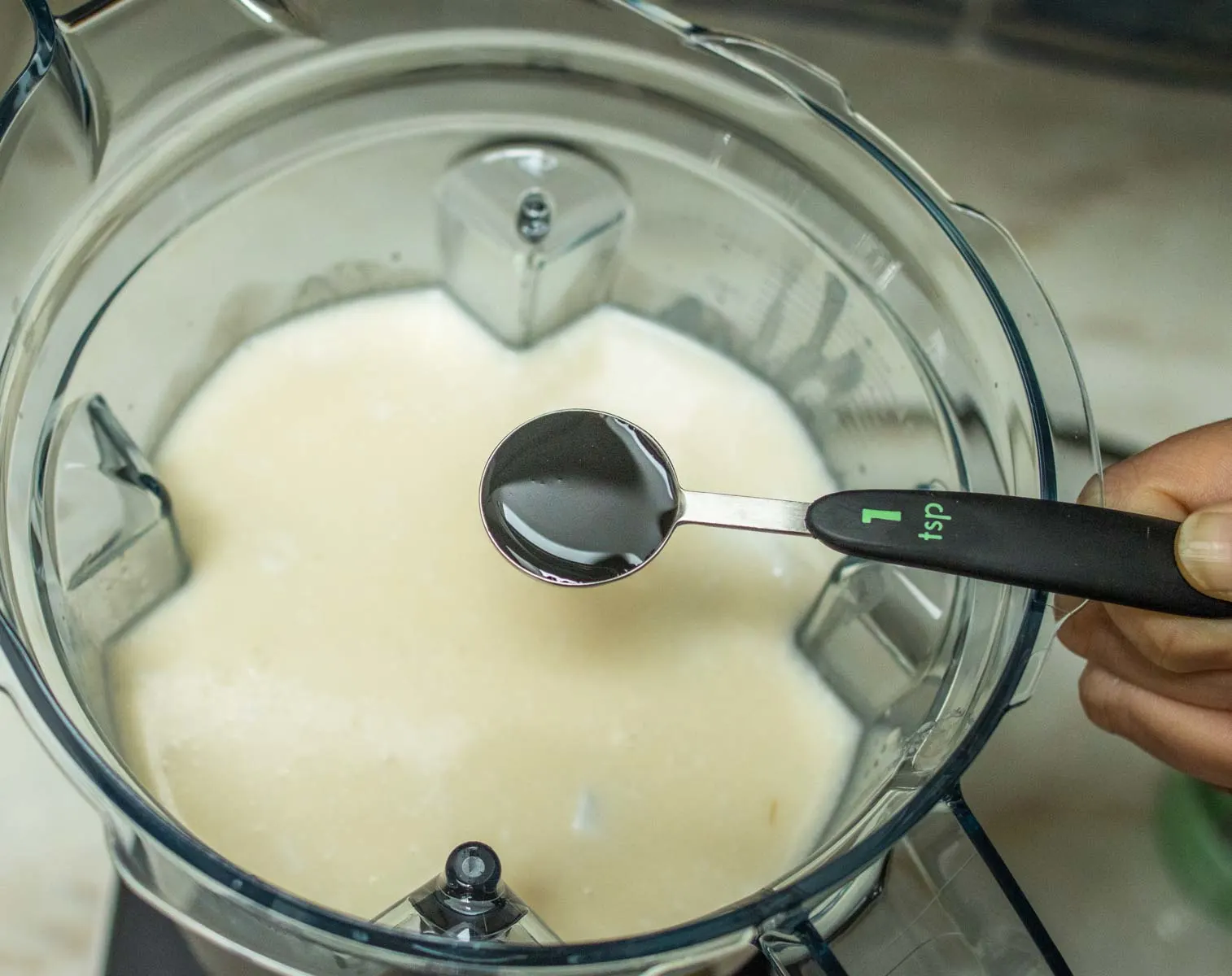 Adding Vanilla to Coquito in Blender